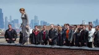 Película divergente: Tris se para en una repisa mientras todos miran