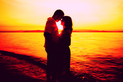 kaksikleegi armastus rannas kirglikus päikesesiluetis