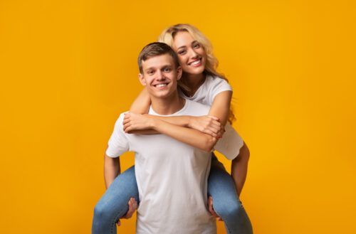 couple heureux sur fond jaune après avoir manifesté une personne spécifique pour tomber amoureux