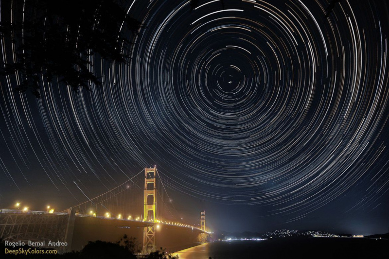 Lorsque la Terre tourne, les étoiles semblent former des cercles dans le ciel autour des pôles. De longues poses révèlent ce mouvement, comme celui extraordinaire du pôle nord céleste au-dessus du Golden Gate Bridge à San Francisco. Crédit : Rogelio Bernal Andreo