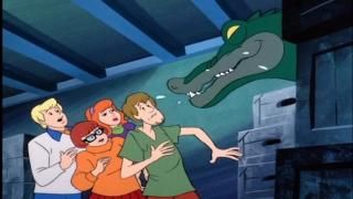 The Scooby Doo Show (TV): Μια αλλιγάτορα γροθιά με σάλιο που στάζει από τους πύργους του στόματος απειλητικά πάνω από τη μυστική συμμορία.