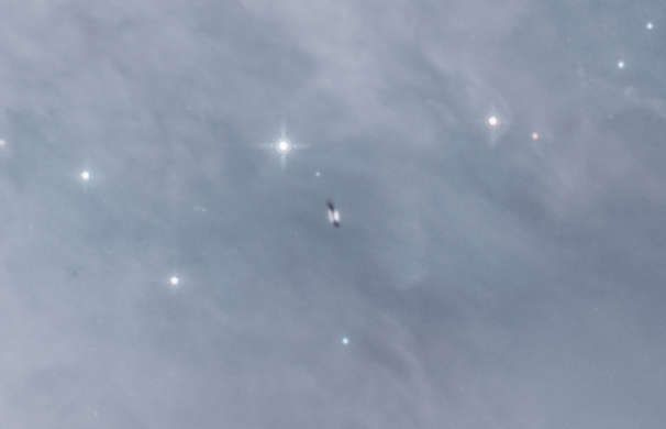 En proplyd, eller protoplanetarisk plate, dypt inne i Oriontåken, hvor en stjerne og kanskje planetarisk system blir født. Kreditt: NASA/ESA/Massimo Robberto/Judy Schmidt